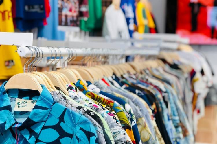 clothes on a rack at a beach store