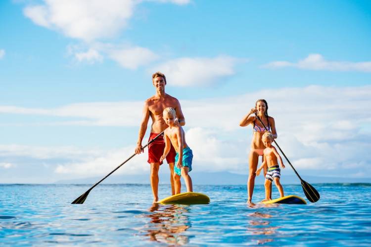 Family stand up paddle boarding together